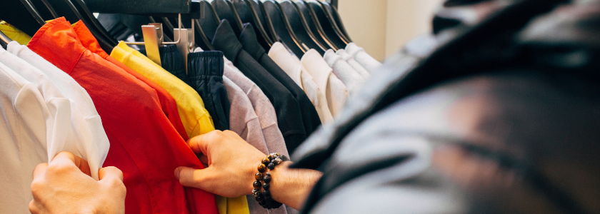 Photo by Charles 🇵🇭 on Unsplash
Photo of man looking through shirts at a store