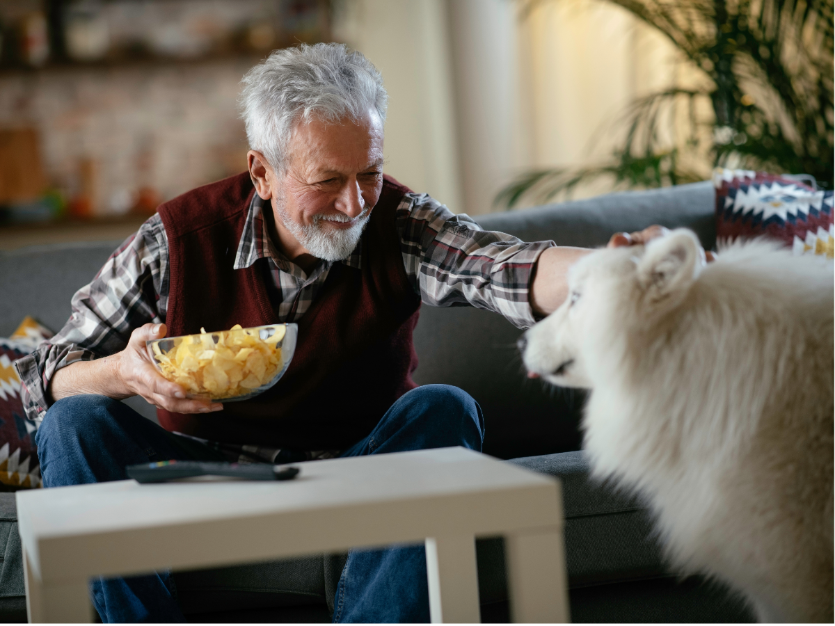 Senior adult enjoying organized home with his dog